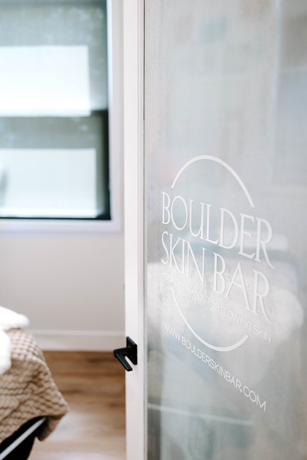 Frosted glass door of Boulder Skin Bar.
