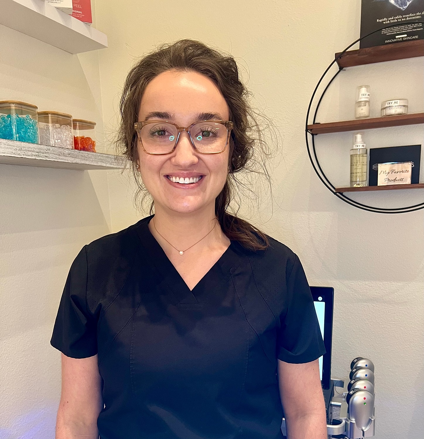 Woman smiling in medical professional attire.